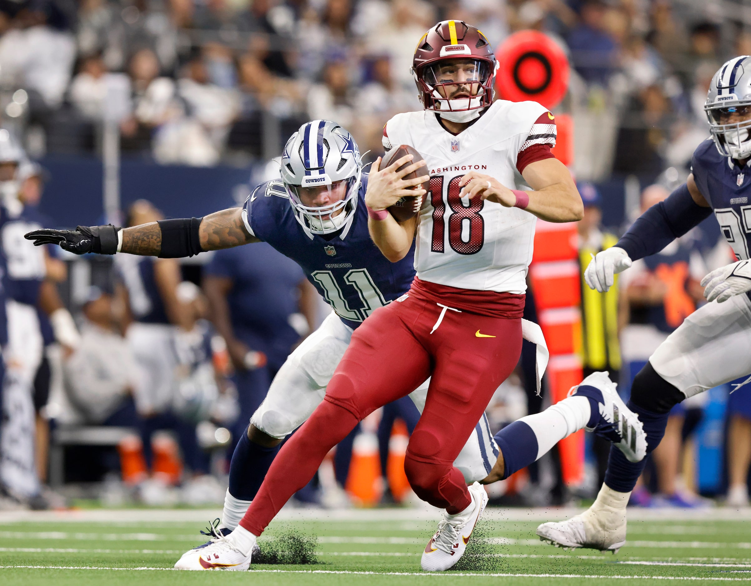 Dallas Cowboys linebacker Micah Parsons (11) chases down Washington Commanders quarterback...