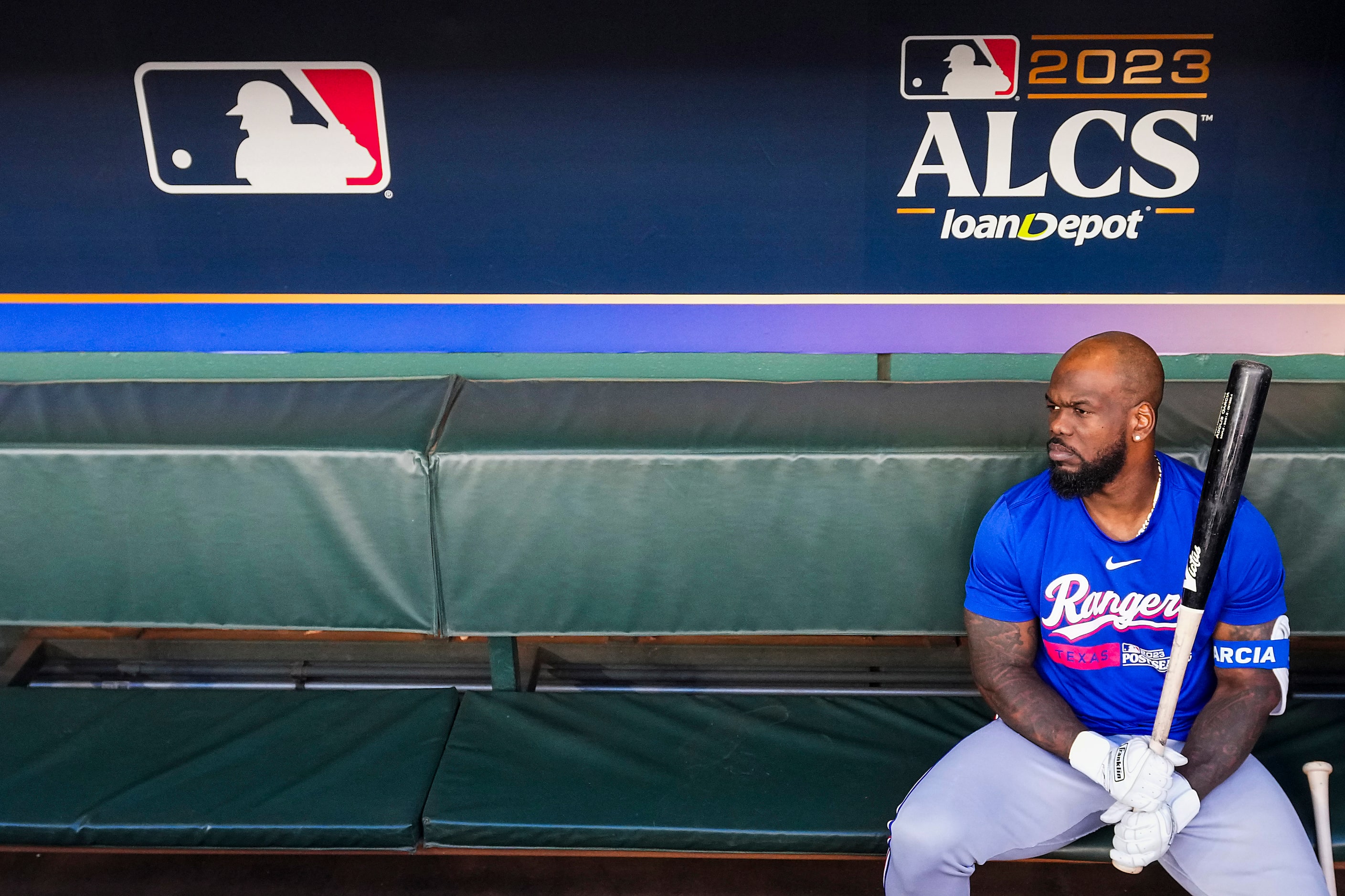 Texas Rangers right fielder Adolis Garcia looks out from the dugout during a workout in...