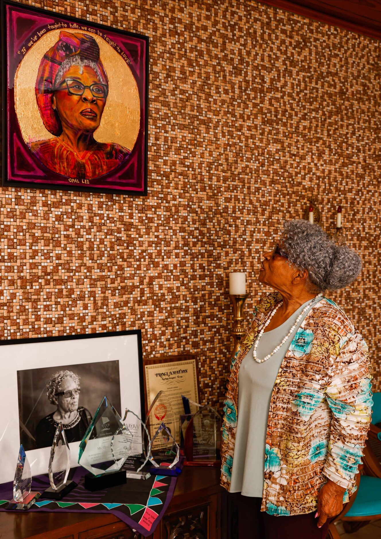 Opal Lee looks at a painting of herself in her home in Fort Worth on Friday, December 10, 2021.