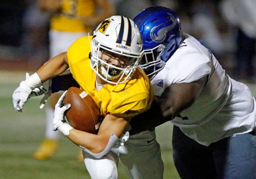 Prestonwood Christian Academy running back Derek Eusebio (3) is brought down by Nolan...