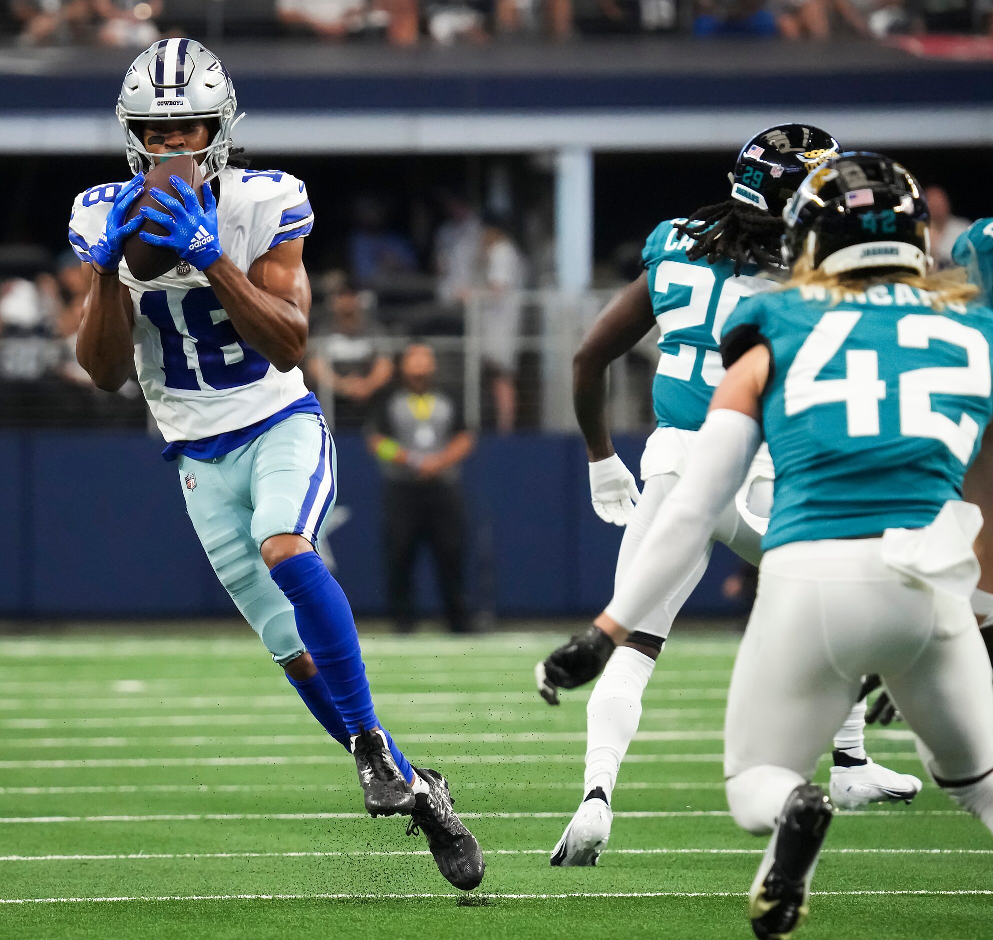 Dallas Cowboys wide receiver Jalen Tolbert (18) catches a pass during the first half of an...