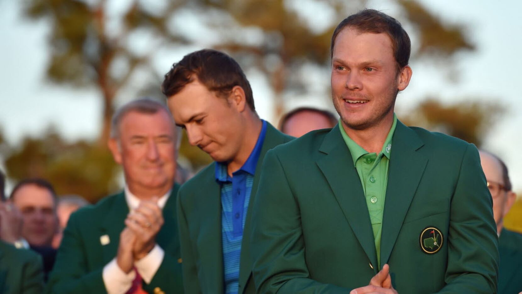 Masters champion Danny Willett gets the Green Jacket from Jordan Spieth following the final...