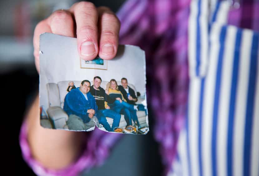 Eddie Garza holds up a photo of himself (left) at his highest weight, over 300 pounds, that...