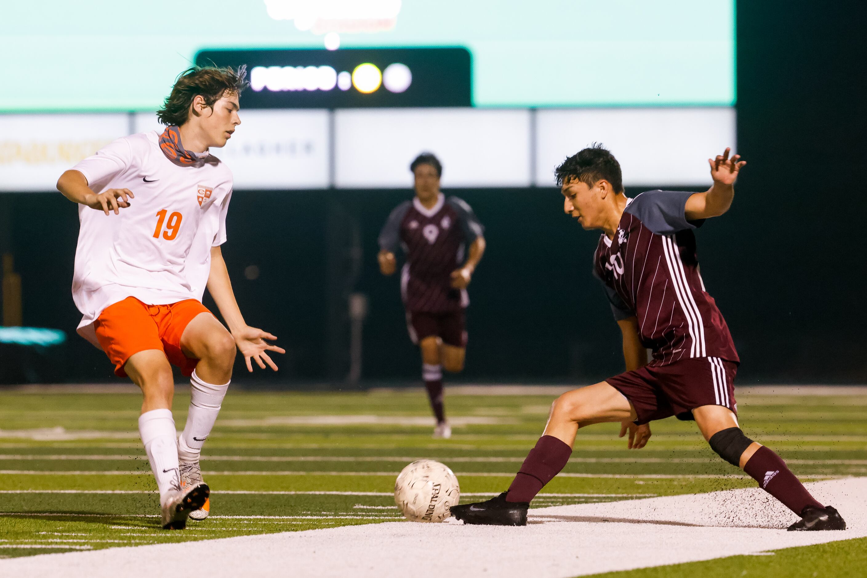 Palestine's Ty Carnes (13) attempts to drive the ball away from Celina's Andy Allam (19)...