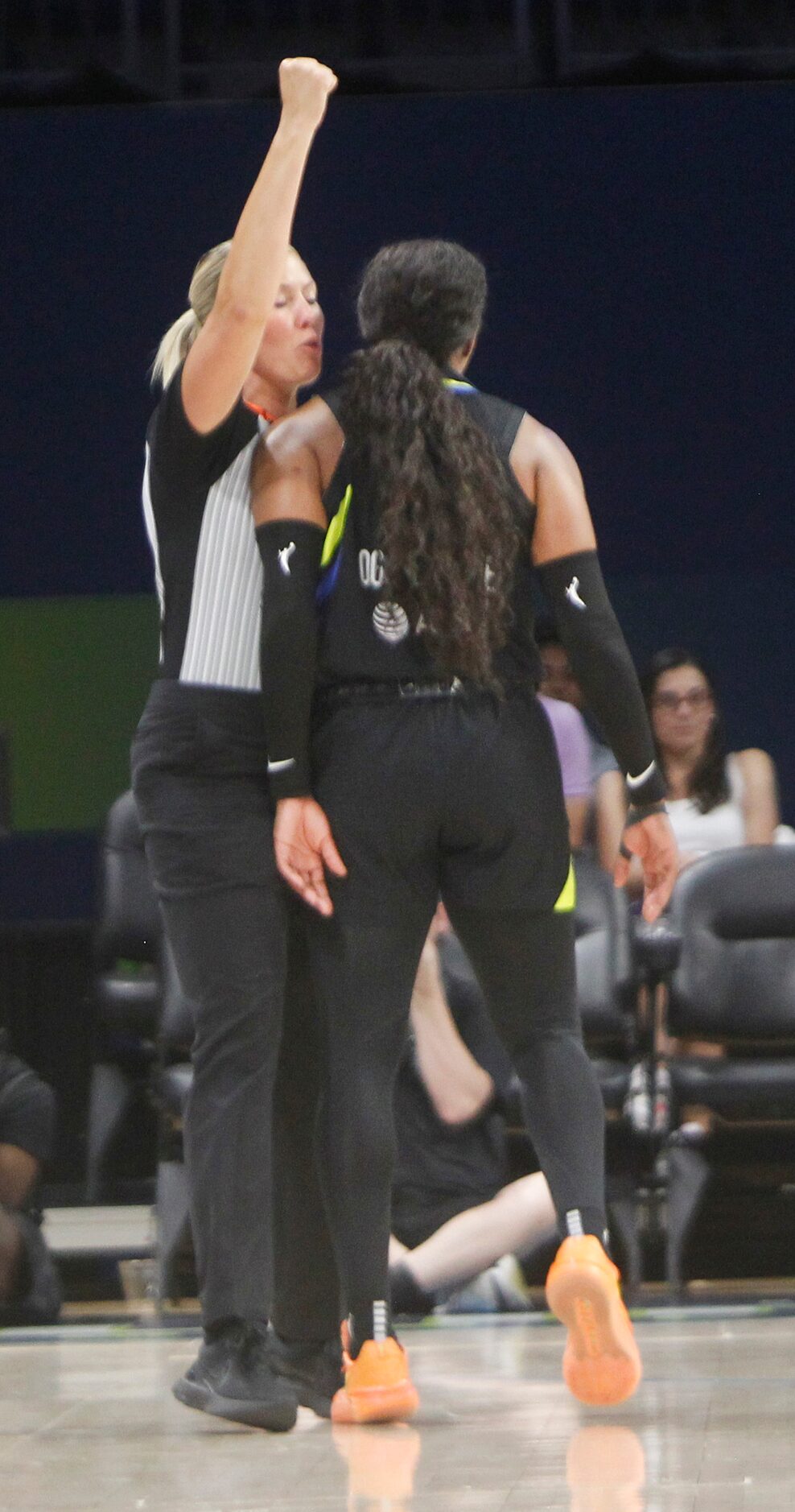 Dallas Wings guard Arike Ogunbowale (24) collides with a game official after being fouled in...