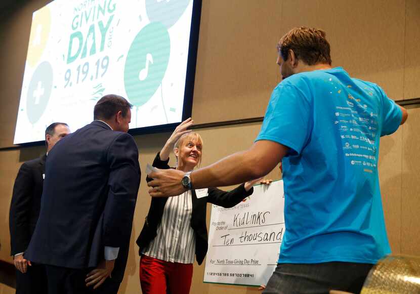 Was Maya Lechowick (center) of the nonprofit KidLinks more excited to get a hug from a...