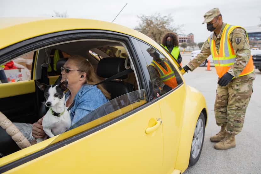 Tina Clark and dog Coco from Fort Worth waited as volunteers and members of the Texas...