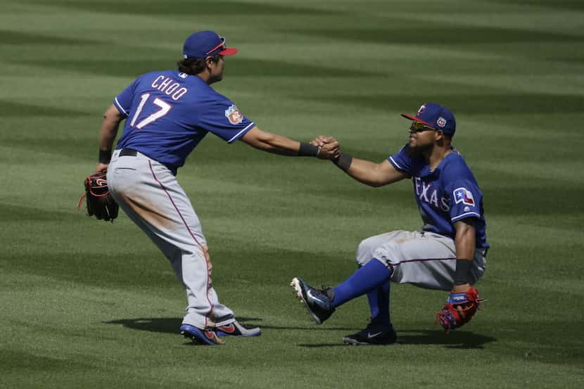 Texas Rangers' Shin-Soo Choo helps Rougned Odor during a spring training baseball game...