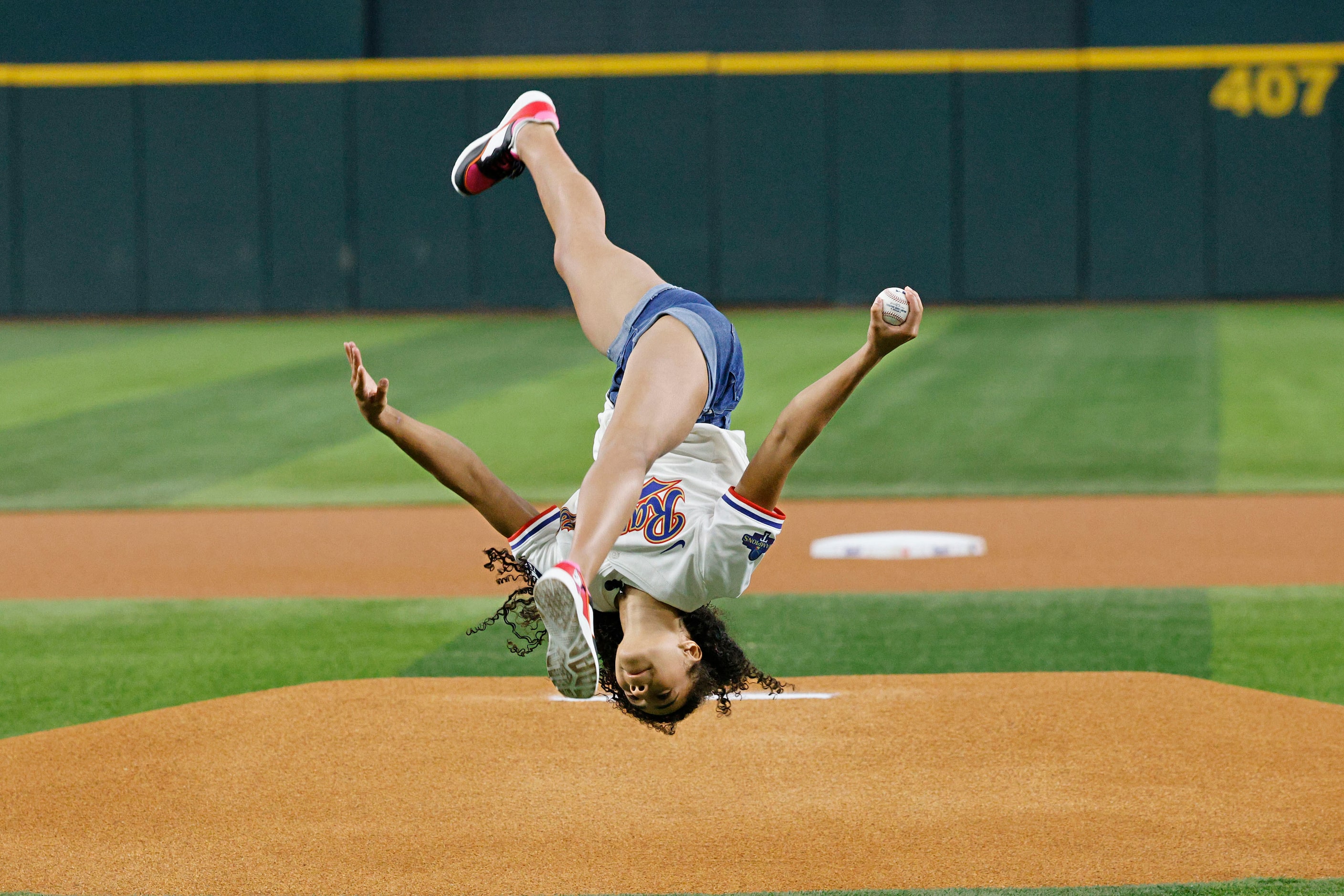 Olympic Gold medalist Hezly Rivera from Plano does a side flip before throwing out a...