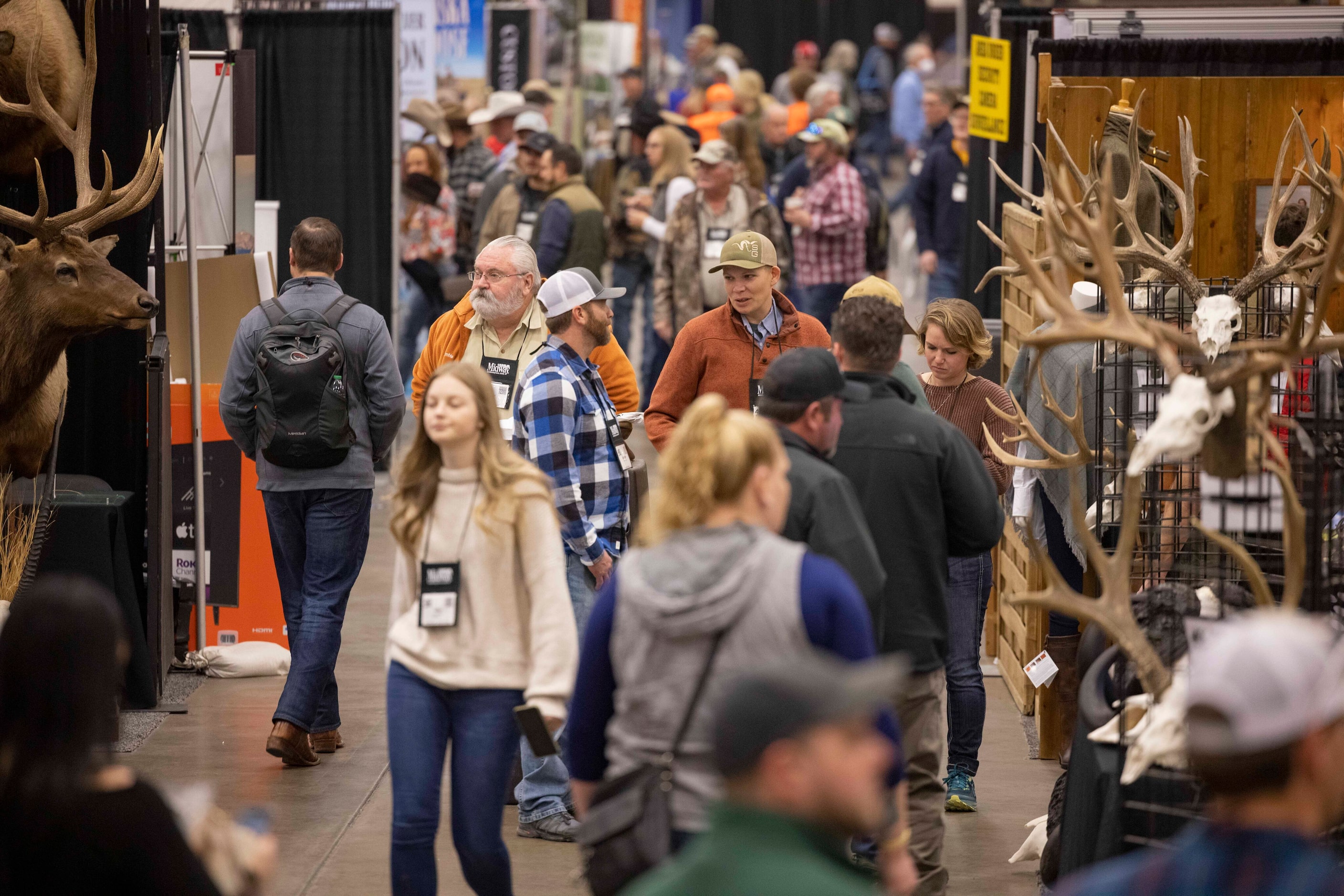 People walk by the booths during the Dallas Safari Club Convention and Sporting Expo at Kay...