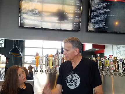 Franchisee Ron Ryan reviews last-minute details with bartender Kristina Ramirez before...