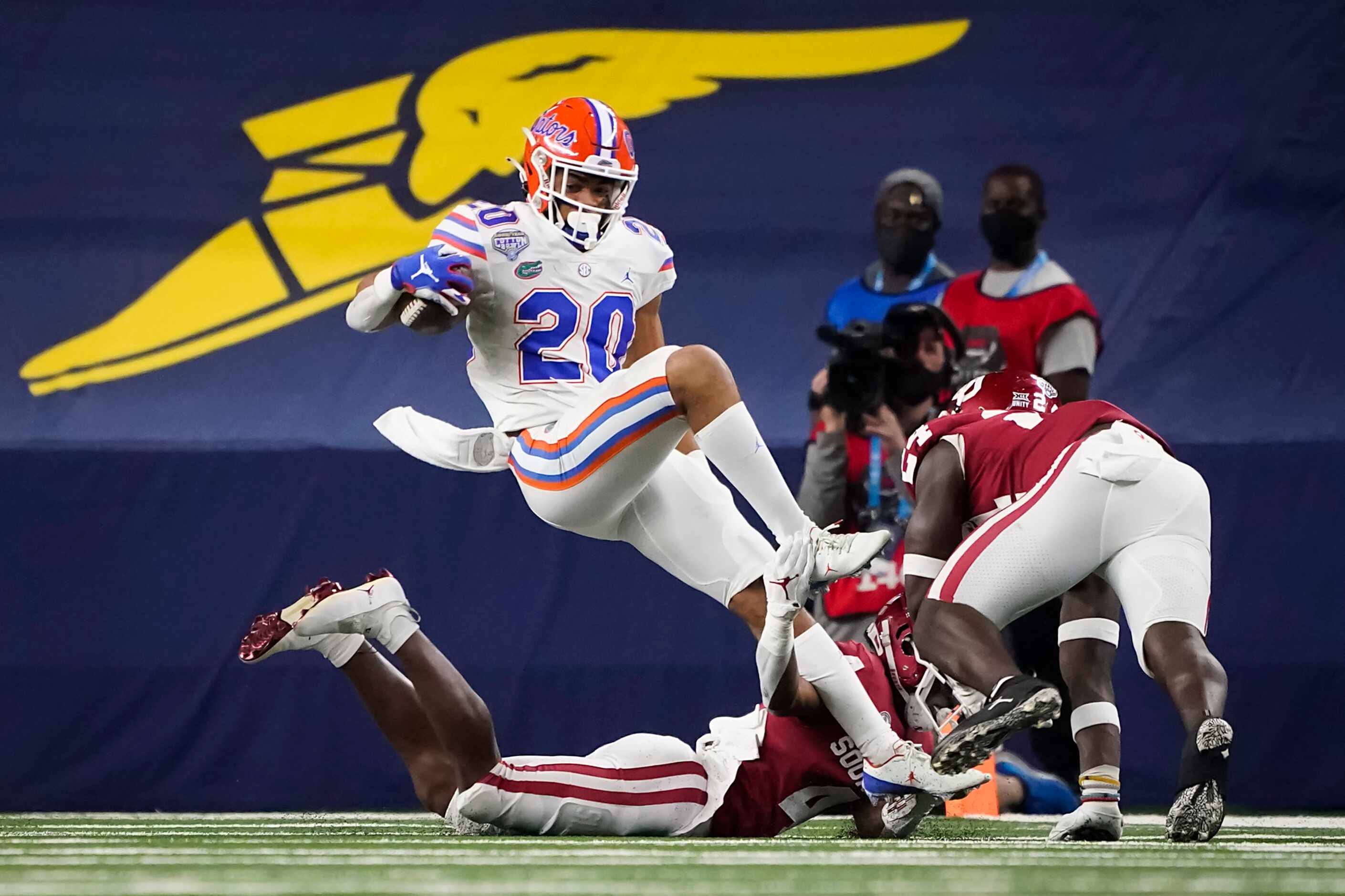 Florida running back Malik Davis (20) is brought down by Oklahoma cornerback Jaden Davis (4)...