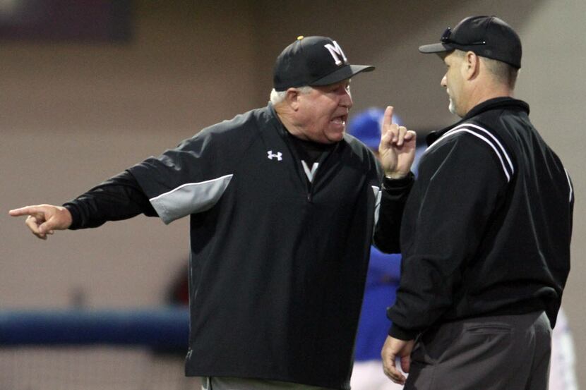 Mansfield head coach Gary Vaughan argues a call with the field umpire after a Midlothian...