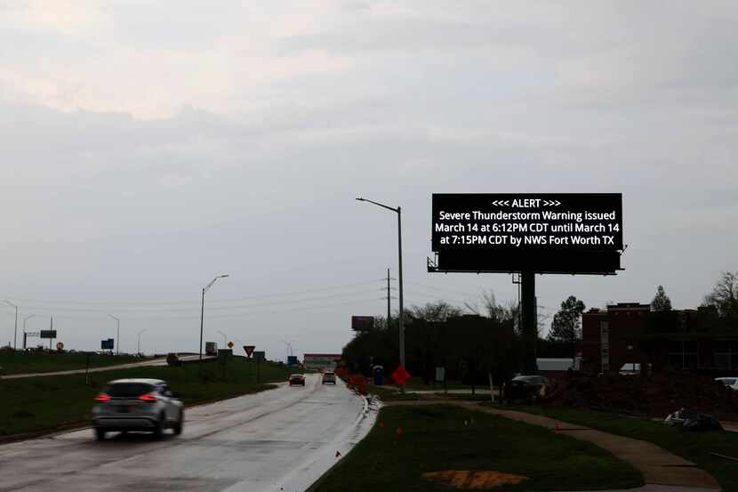 A thunderstorm cautionary sign posted along I-35 frontage road on, Thursday, March 14, 2024,...