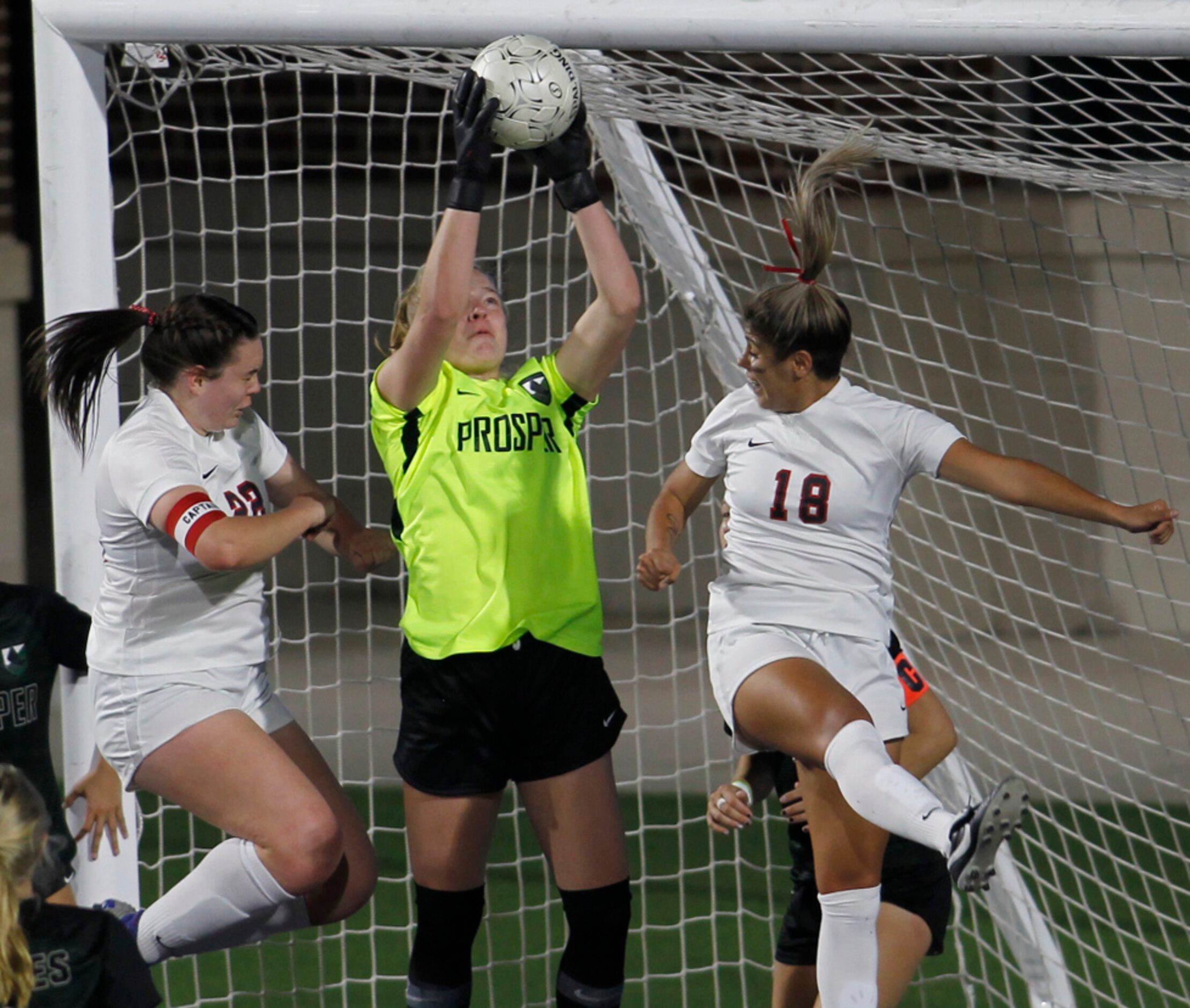 Prosper goalkeeper Jordyn Gunnarson (31) skies to deny a  scoring attempt as she is framed...