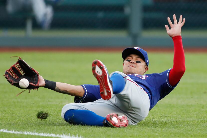 Texas Rangers left fielder Shin-Soo Choo is unable to catch a fly ball hit by Kansas City...
