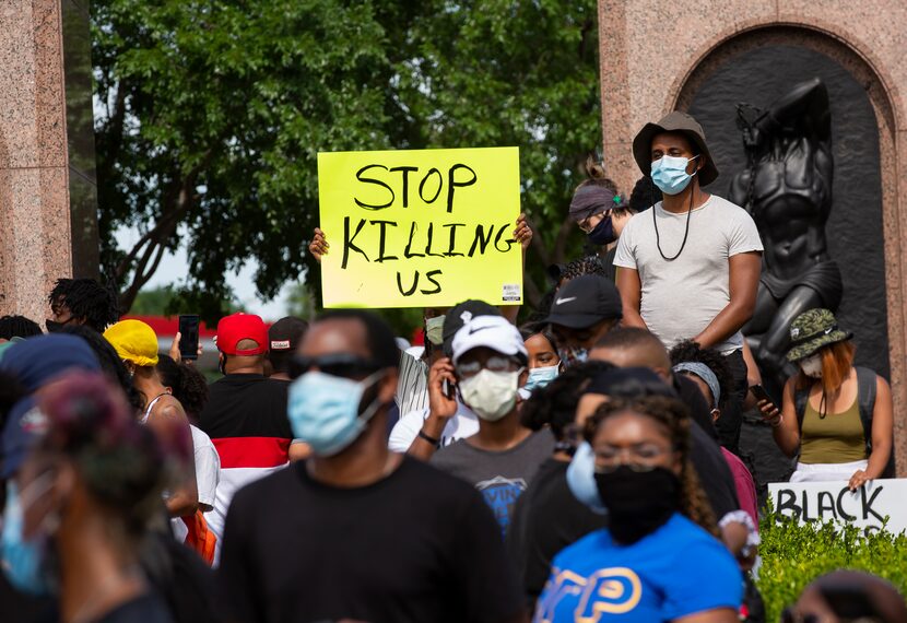 Demonstrators stage a vigil to honor those lost as a result of police brutality at...