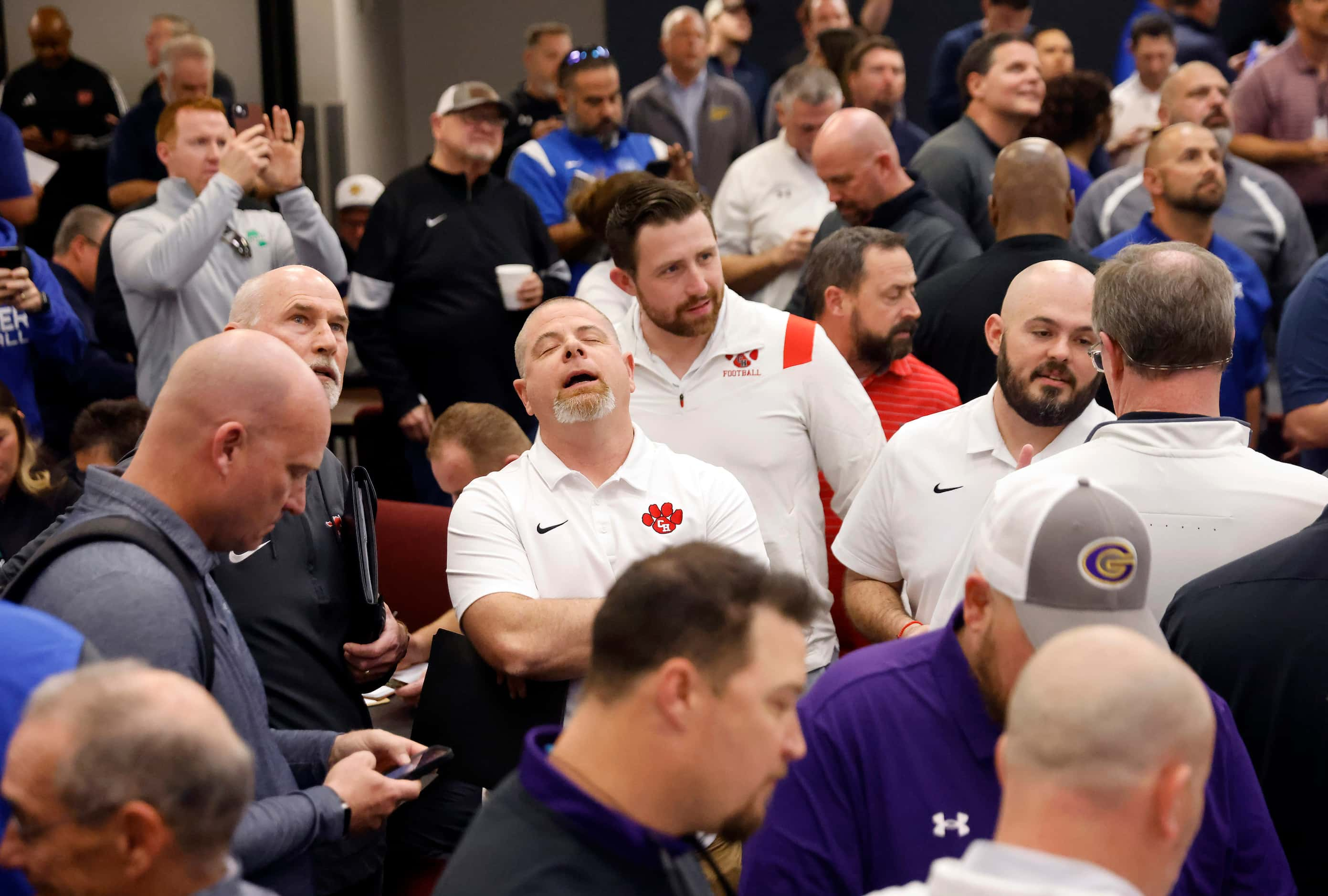 Colleyville Heritage head football coach Jerry Edwards (center) reacts to seeing his team...