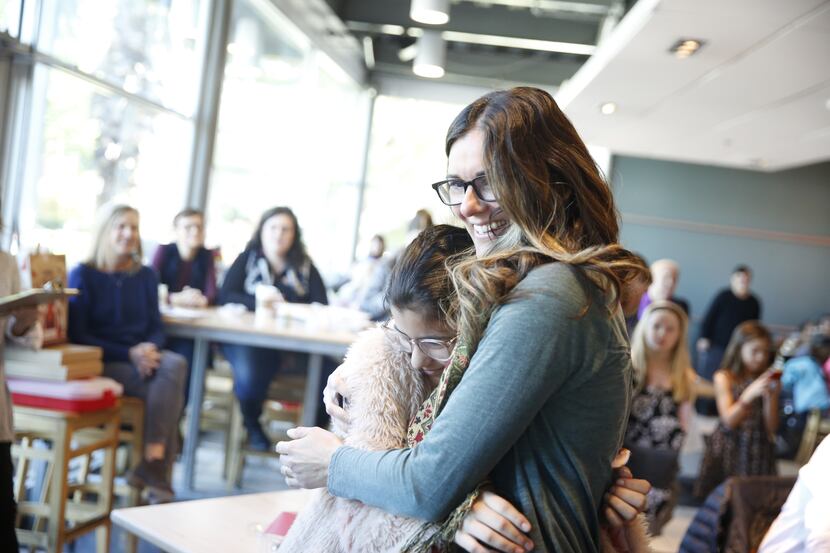 Sheila Bustillos hugs her daughter after winning in The Dallas Morning News cookie contest...