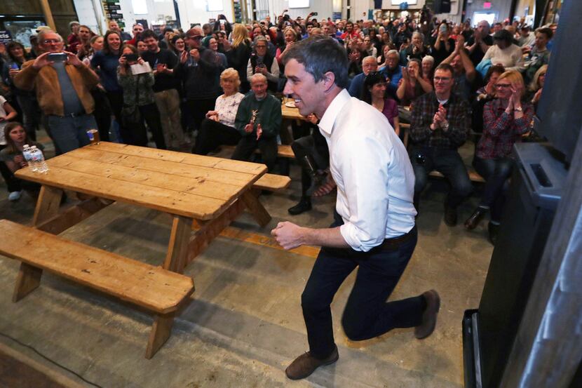 Former Texas congressman Beto O'Rourke dashes to the stage as he arrives for a campaign stop...