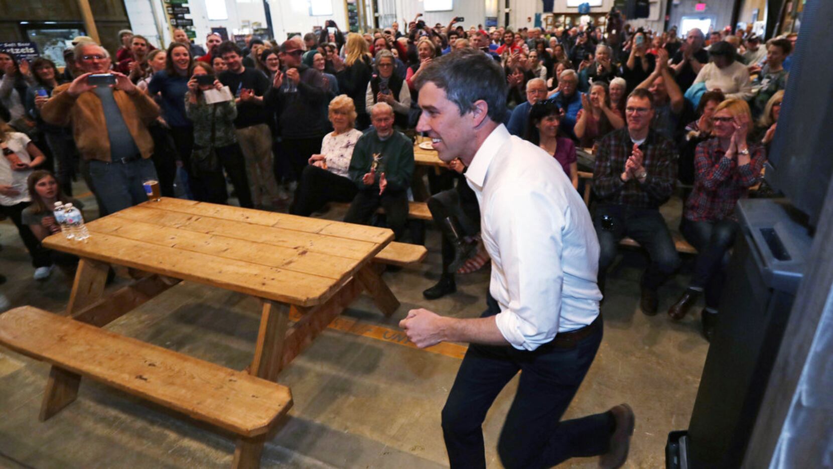 Former Texas congressman Beto O'Rourke dashes to the stage as he arrives for a campaign stop...