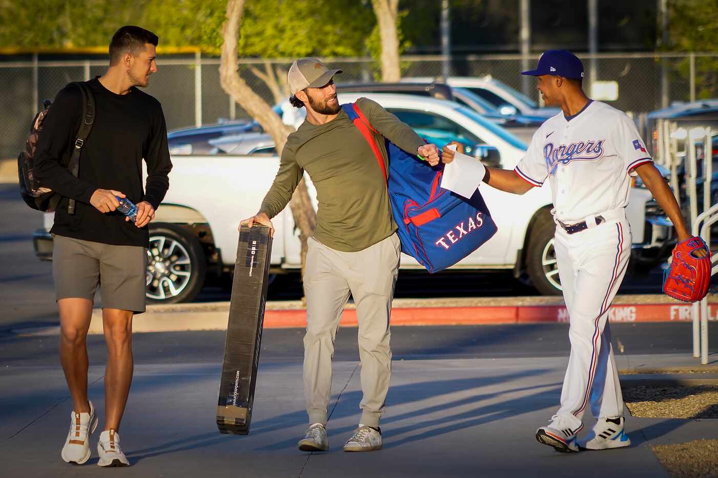 Texas Rangers infielder Charlie Culberson (center) is greeted with a fist bump by pitcher...