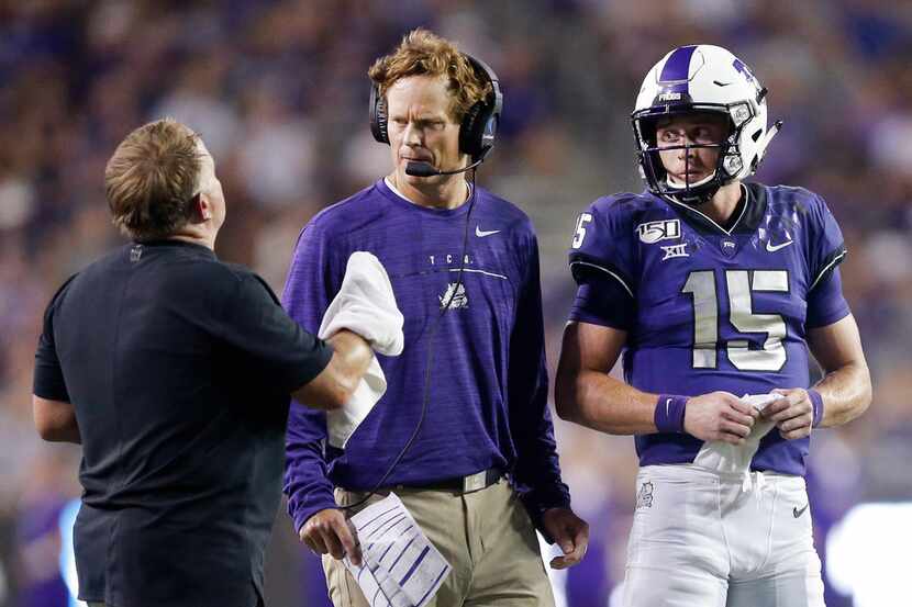 FILE - TCU co-offensive coordinator Sonny Cumbie (center) confers with head coach Gary...