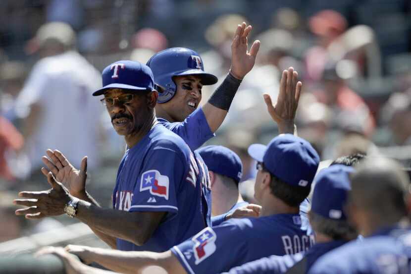 Leonys Martin #2 of the Texas Rangers celebrates scoring a run against the Minnesota Twins...