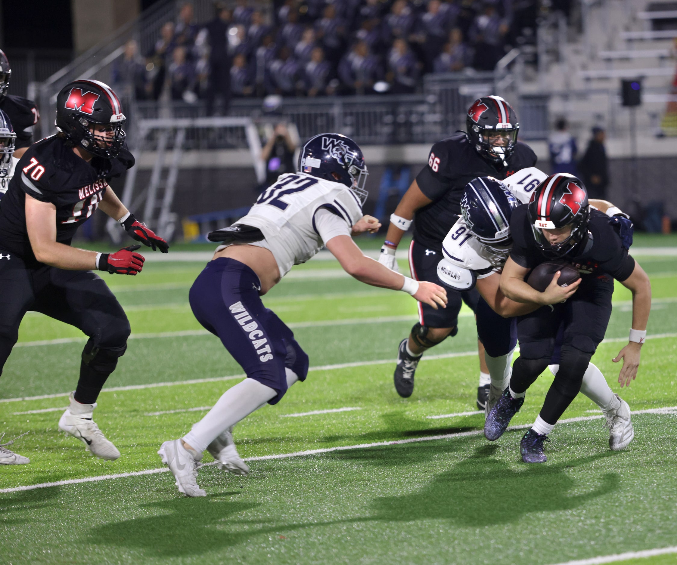 Walnut Grove player #91 Hans Randall grabs onto Melissa player #10 Noah Schuback during the...