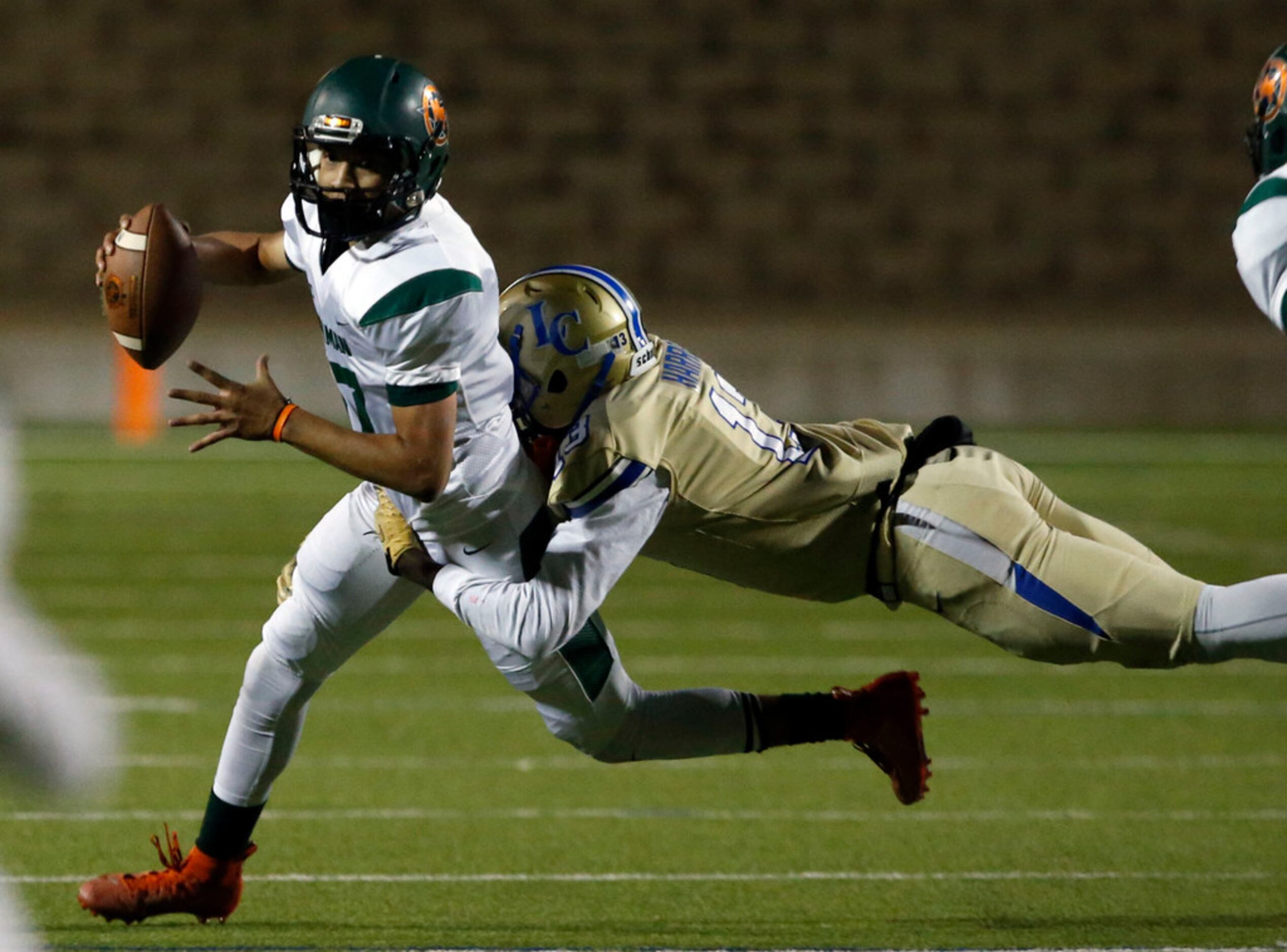 Naaman Forest QB Jayden Flores (17) is grabbed by Lakeview defender Gavin Harris (13) during...
