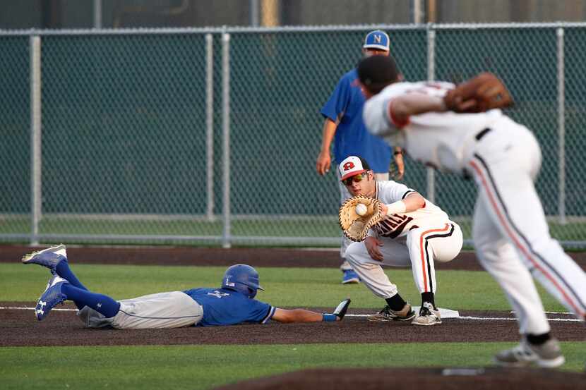North Mesquite's Arturo Gayton beats the pick off attempt from Rockwall starting pitcher...