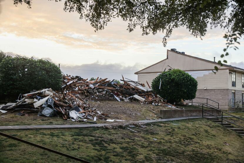 Rubble from Wednesday's explosion at the Highland Hills Apartments and the subsequent razing...