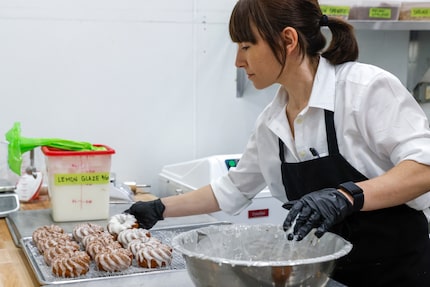 Owner Amy La Rue glazes crullers at La Rue Doughnuts in Trinity Groves, Wednesday, Aug. 28,...