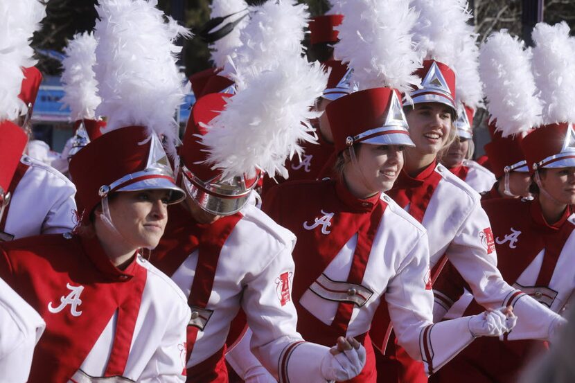 Members of the Alabama Crimson Tide marching band face off against the Michigan State band...