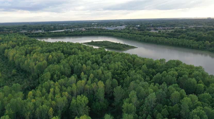 Aerial photography shows the 30-acre Parkdale Lake and its small island as well as some of...