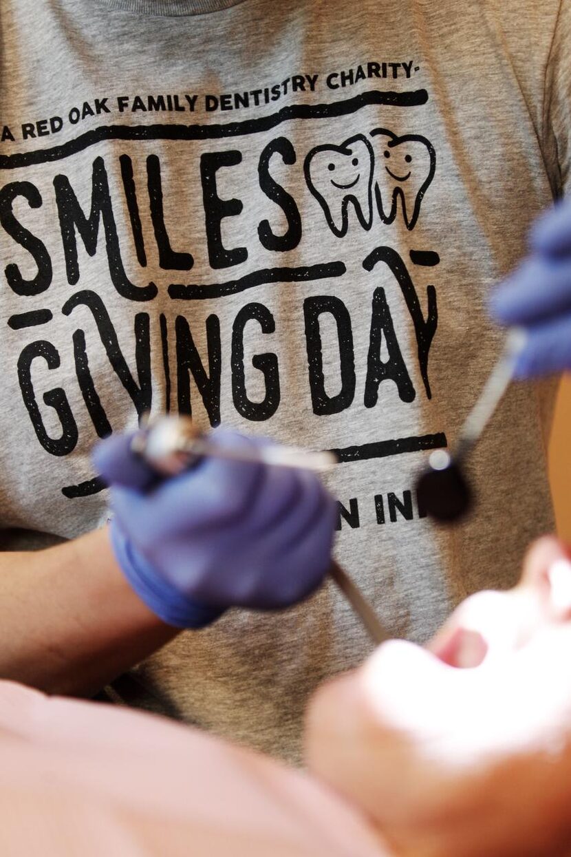 
Dr. Anthony Do inspects a tooth that had been bothering Donna Johnson during the Smiles...