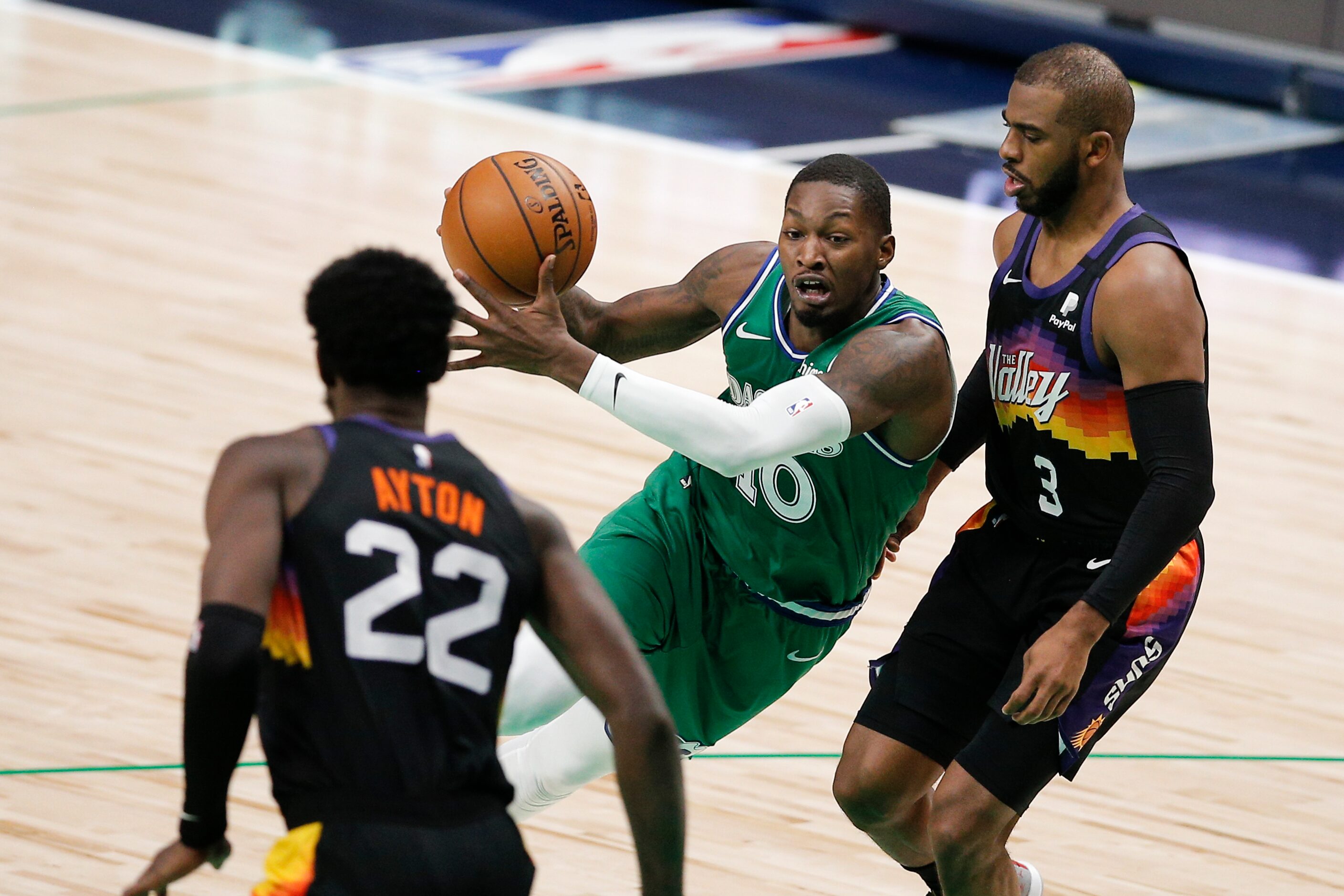 Dallas Mavericks forward Dorian Finney-Smith (10) battles Phoenix Suns forward Deandre Ayton...