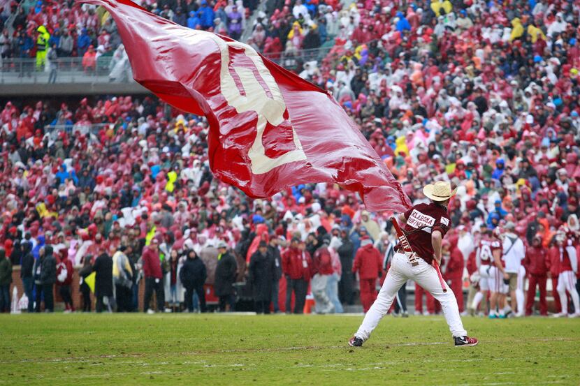 NORMAN, OK - DECEMBER 3:  A member of the Oklahoma Sooners spirit squad waves a wet flag...