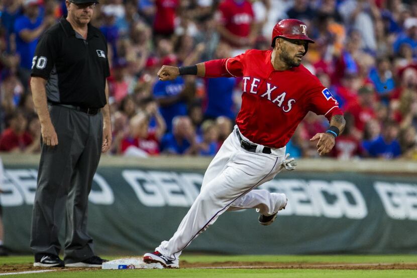 Texas Rangers center fielder Ian Desmond (20) steals third base during the fifth inning of...