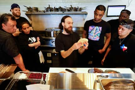 Liad Balki, (center) director of culinary operations, teaches Dallas chefs at Miznon about...