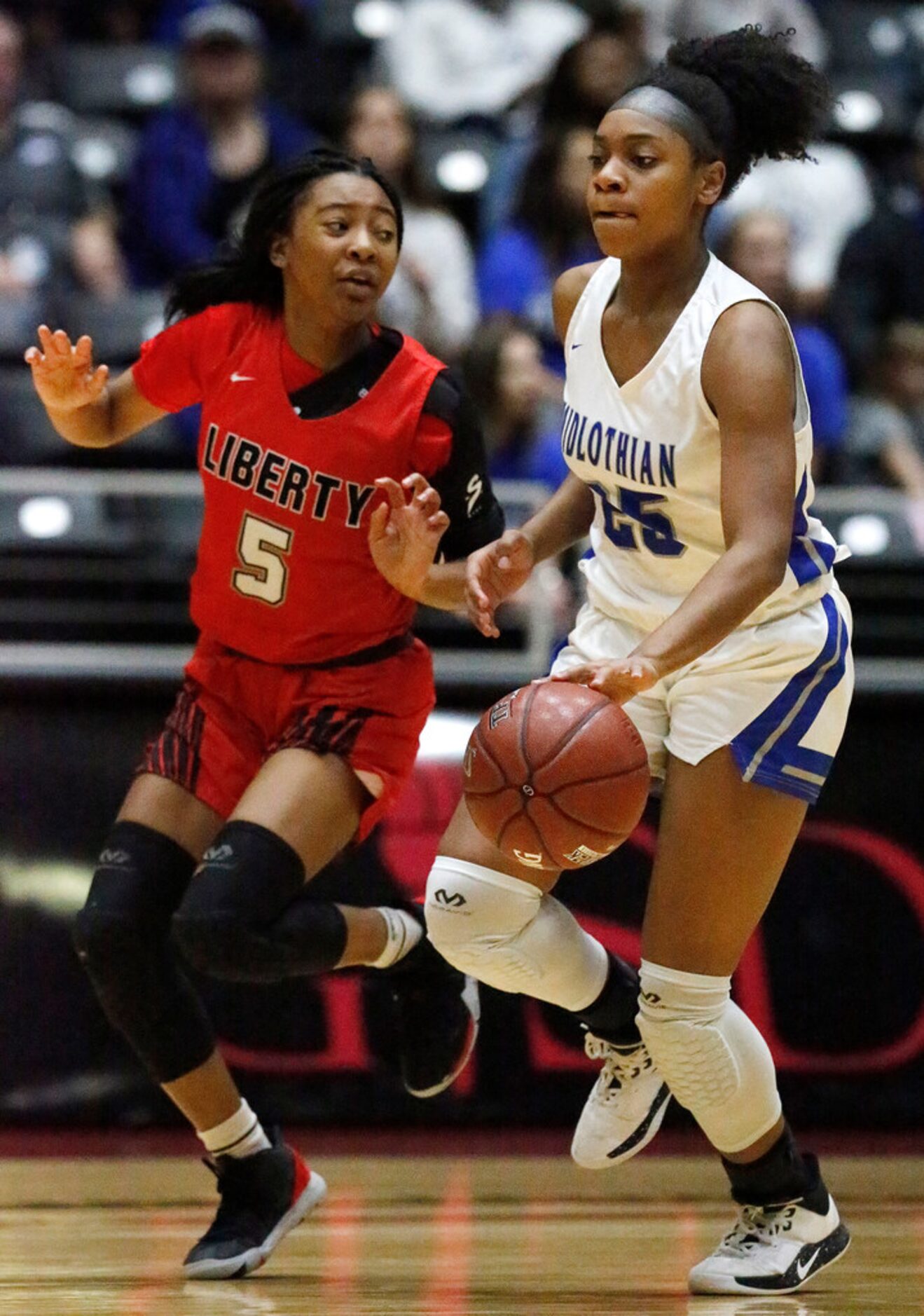 Midlothian High School guard Kadia Ward (25) is defended by Frisco Liberty High School...