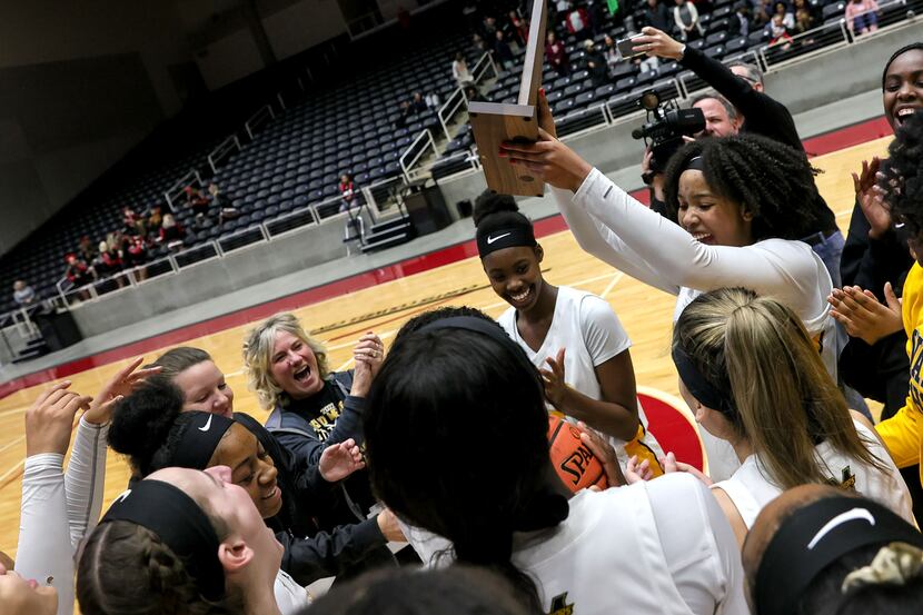 The Frisco Memorial Lady Warriors celebrate their victory over Frisco Liberty, 43-35 in the...