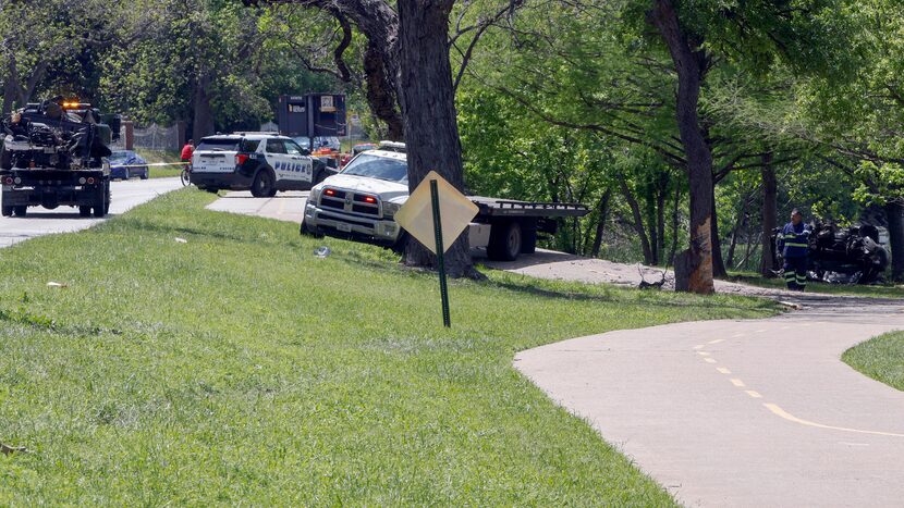 Tow truck operators on Tuesday prepared to move pieces of the pickup that veered off Garland...