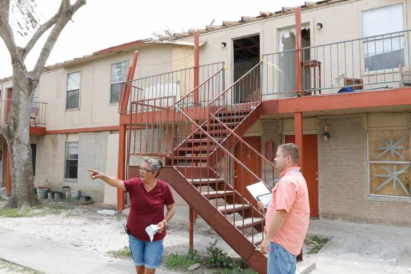Refugio Apartments manager Cindy Faulkner (left) talks with a FEMA contract worker as he...