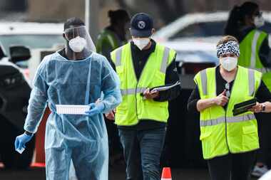 Dallas County staff with support from FEMA and Army medics, administered COVID-19...