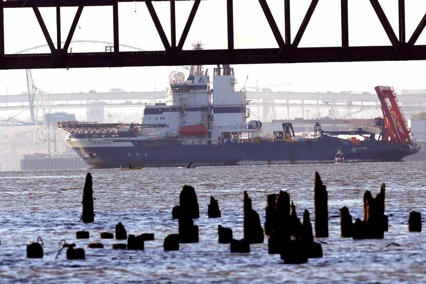 Royal Dutch Shell PLC icebreaker Fennica heads under a railroad bridge back to the Port of...
