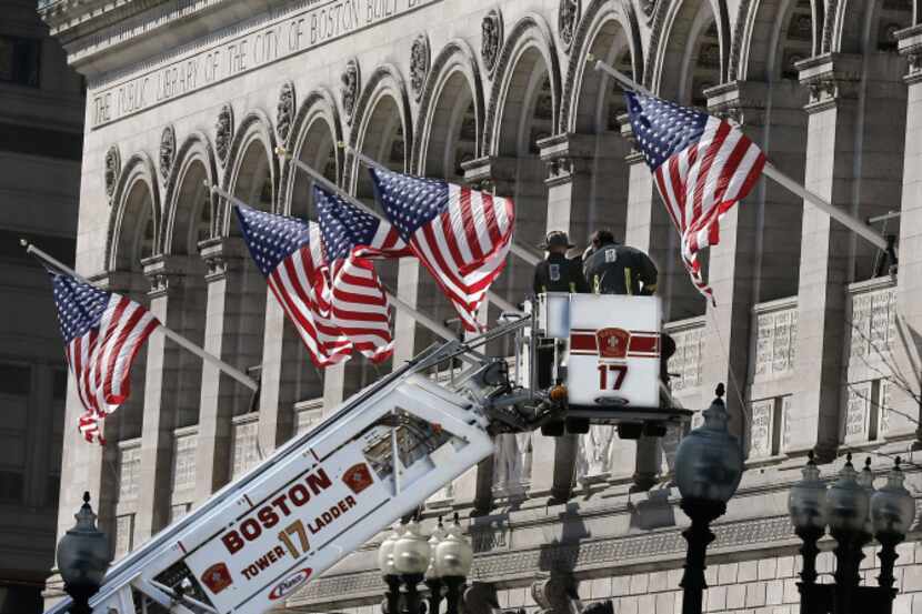 Responders search the area around the Boston Public Library near the finish line of the...