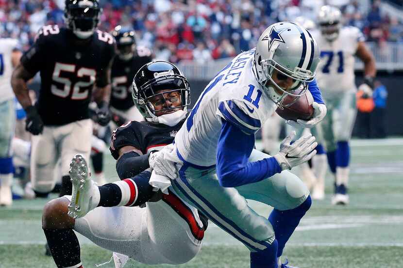 Dallas Cowboys wide receiver Cole Beasley (11) spins Atlanta Falcons cornerback Robert...