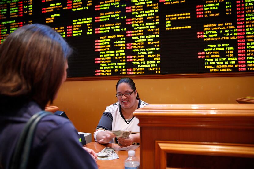 Crystal Kalahiki pays out a bet in the sports book at the South Point hotel-casino, Monday,...