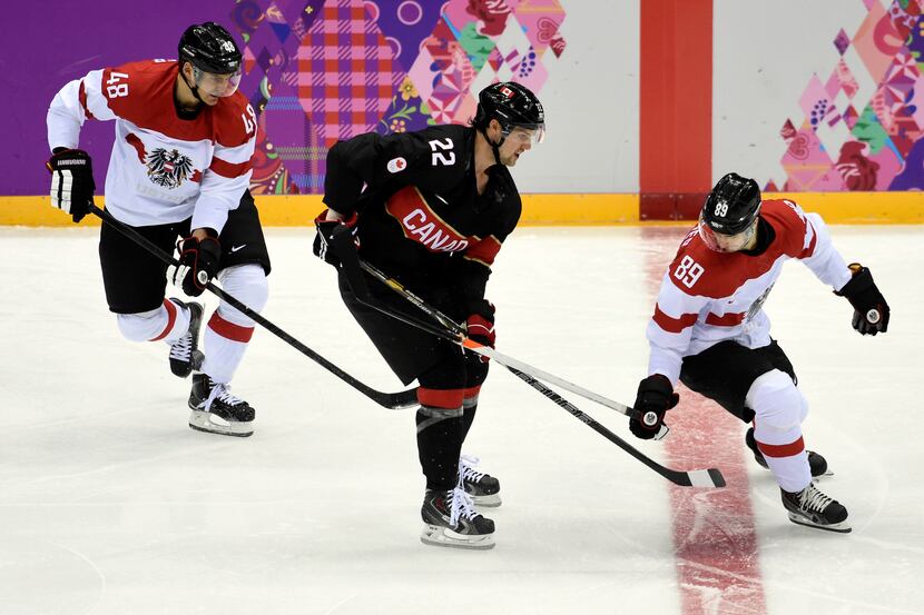Feb 14, 2014; Sochi, RUSSIA; Canada forward Jamie Benn (22) battles for the puck between...